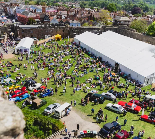 Ariel shot showing the ludlow spring festival at the castle with lots of tents and people